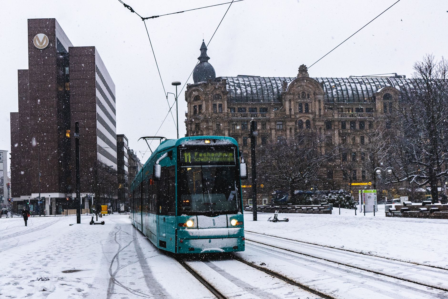A Frankfurt tram crossing a snow-covered square in falling snow